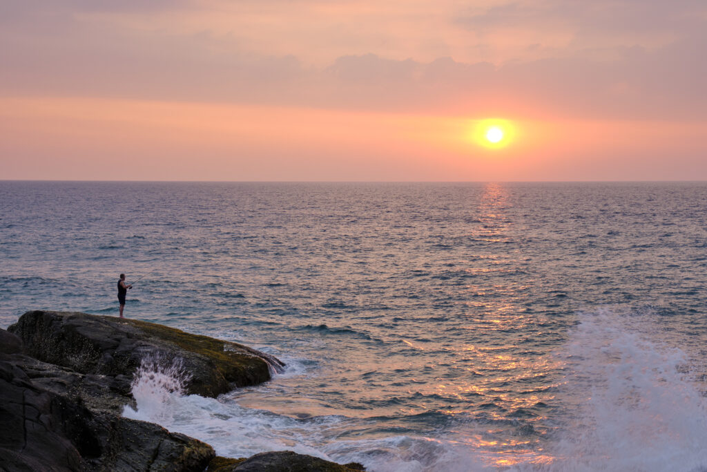 Sri Lanka, Galle District, Ahungalla. Tourist enjoys the sunset