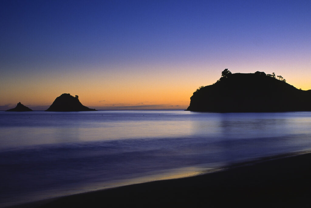 An old film shot (2000) taken at dawn on Hahei Beach in the Coro