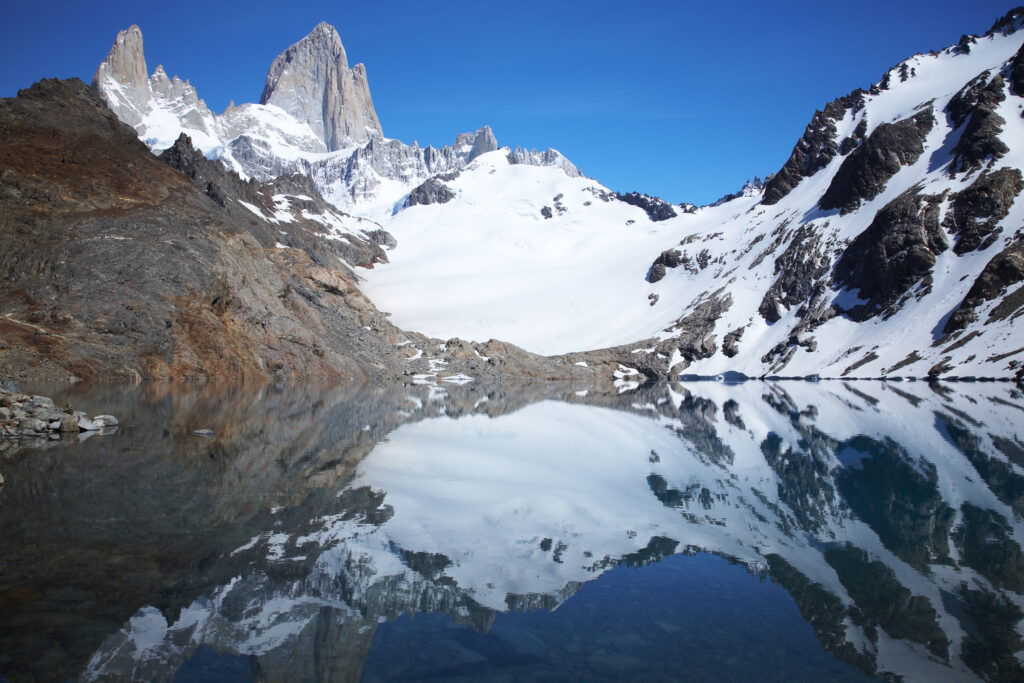 Argentina, Patagonia, Los Glaciares National Park. Fitz Roy and surrounding mountains reflected in the still waters of the ‘de los tres’ lake.