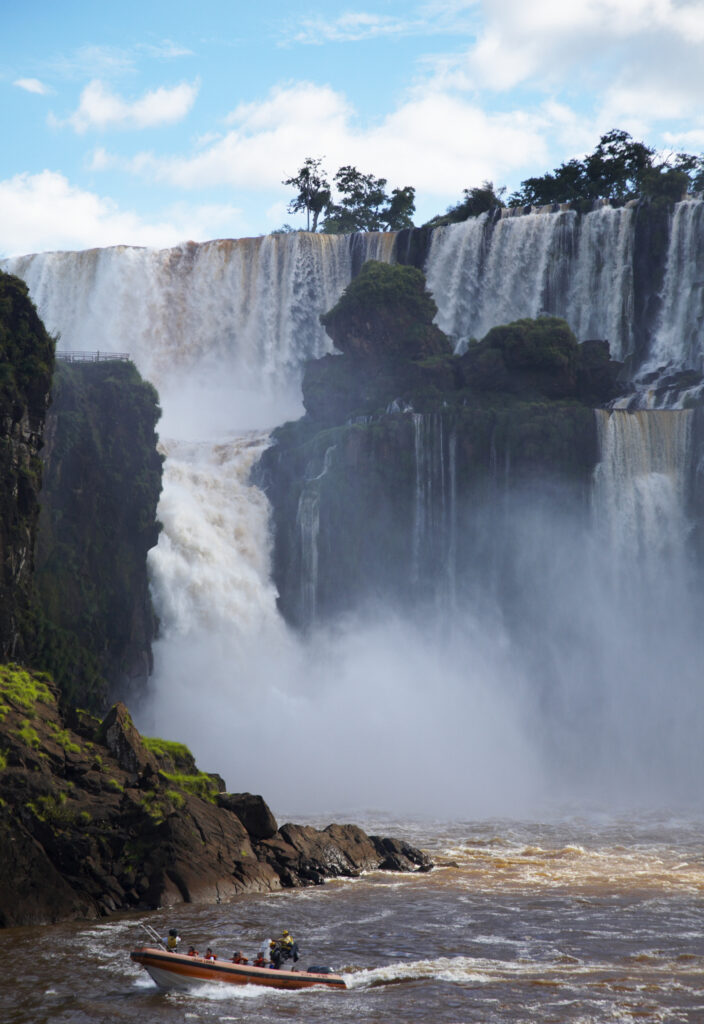 Argentina, Misiones, Iguazu National Park. Tourist boat trip near the impressive Iguazu waterfalls – A world heritage site.